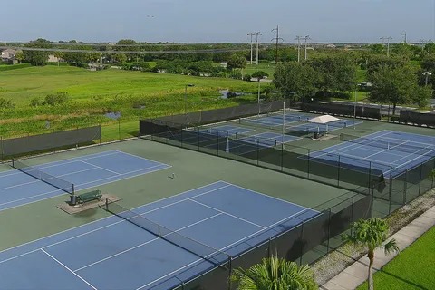 Community racquet courts beside a green nature preserve