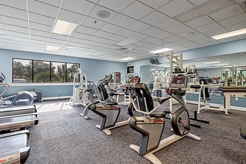 Bright community fitness room with cardio and strength equipment