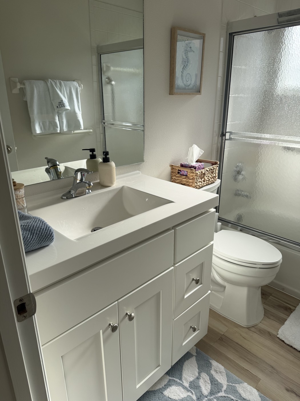 Guest bathroom with a bright vanity and shower-tub combination