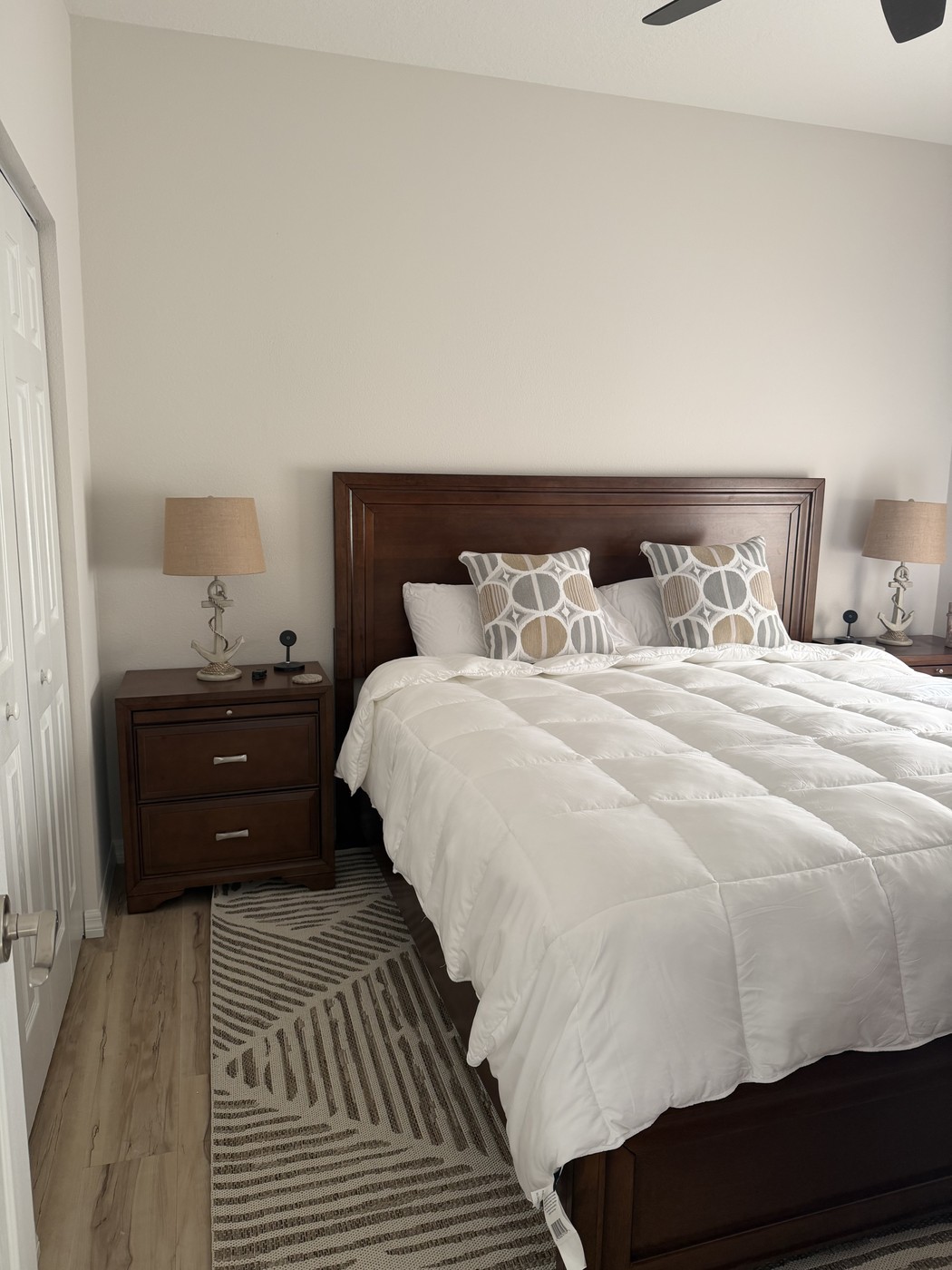 Guest bedroom with a king-size Four Seasons mattress, matching nightstands, and warm wood furniture