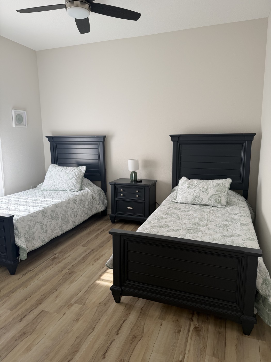 Second guest bedroom with two twin beds and a shared nightstand