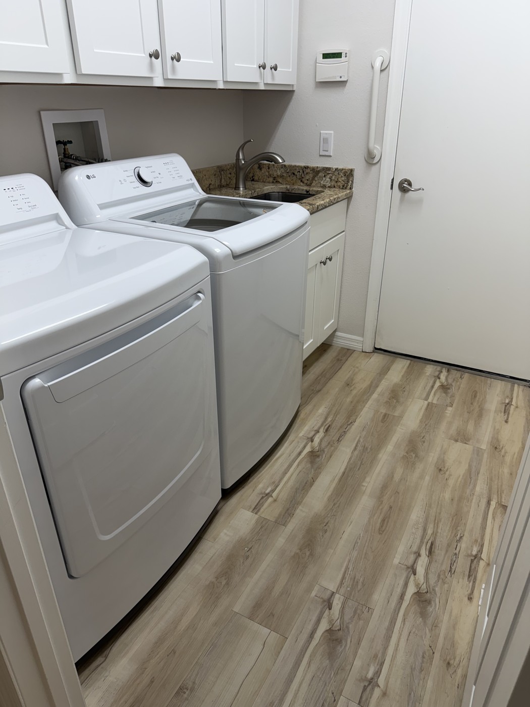 Separate laundry room with full-size washer and dryer