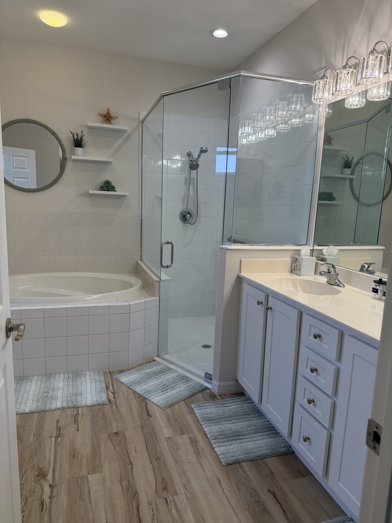 Ensuite bathroom with soaking tub, glass shower, and vanity